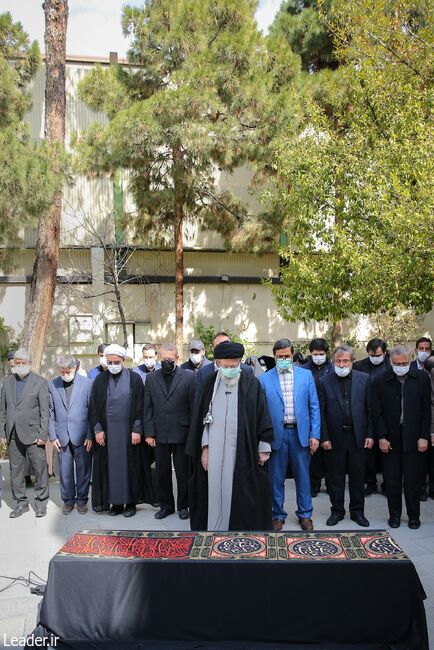 The Leader of the Revolution setting up prayer on the deceased body of martyr Ayatollah Motahari's wife